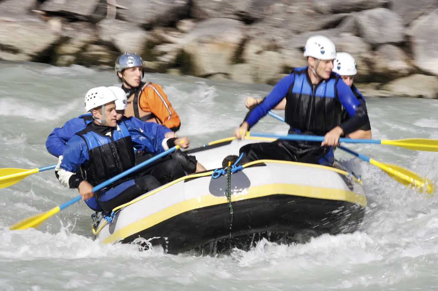 A raft charging through a whitewater rapid