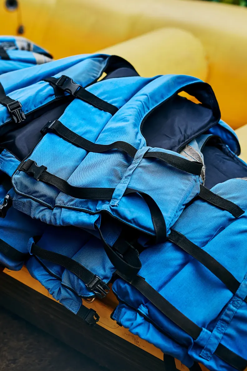 Life jackets stacked in a yellow raft